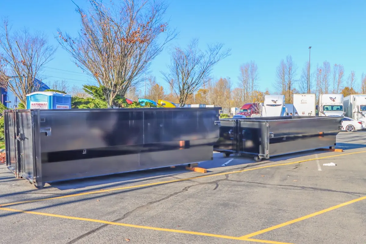 Professional dumpster rental service with roll-off container on residential driveway in Pewaukee